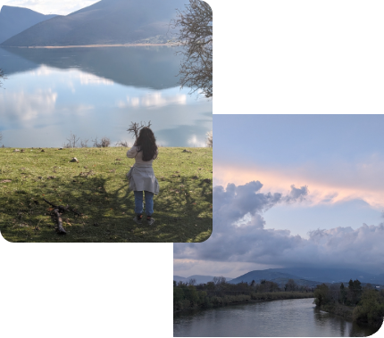 Anna photographing a still lake, with a river and pink clouds beside her